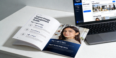 A detailed guidebook and laptop showing the Yupoo platform interface for managing images