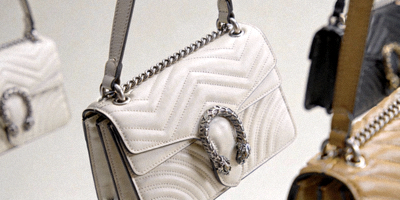 High-definition studio photography of designer handbags showcasing fine details, stitching, and materials