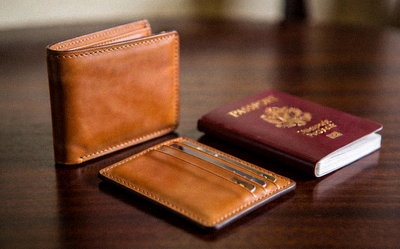 A set of elegant leather wallets including a bifold, cardholder, and passport cover