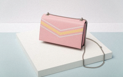 Modern geometric shaped handbag in navy blue with silver architectural hardware